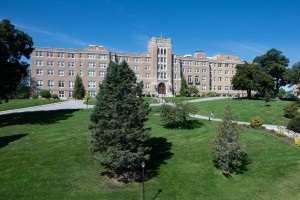 A wide angle shot of the Dominican Center, showing parts of the DC stairs with students walking on a bright sunny day.