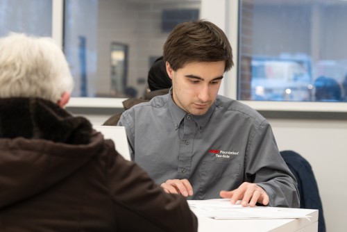 Accounting student working with a member of the community.