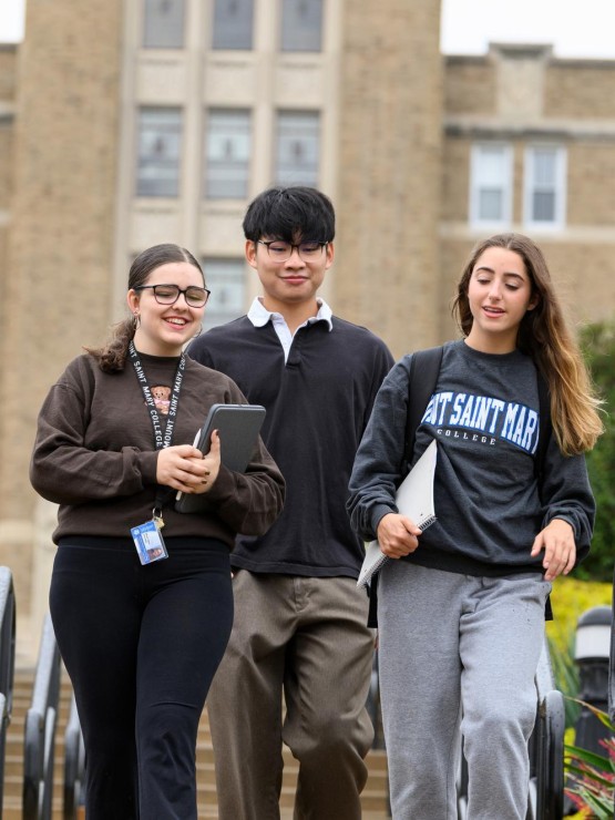 A group of students on the DC stairs walking in the rain.