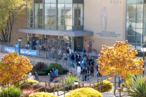 Group of prospective students and their families walking out of a campus building.