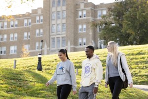 Three students walking on campus.