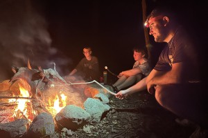 Three Mount Saint Mary College Biology students take a break and roast marshmallows around the campfire during a recent camping trip that focused on experiential learning and the natural sciences. Left to right, Aleksandra Belugin of New Windsor, N.Y.; Ja
