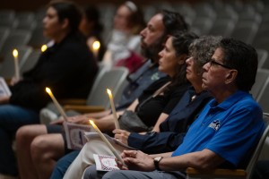 Attendees and community members hold illuminated candles in quiet reflection during the Mount's 9/11 memorial vigil. 