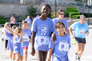 ALT: Many people running and smiling at Mount Saint Mary College. 