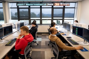 A. Reza Hossain, professor of Economics (front right) and his students analyze real-time financial data in the new Joseph F. Maloney Memorial Investment Lab at Mount Saint Mary College.