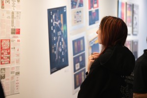 A student looking at art work in the CMA Gallery in Aquinas Hall