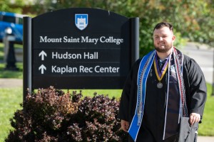 Man wearing graduation garb smiles at camera. Daniel Csaszar of Hopewell Junction, N.Y., a history and special education major, graduated from 91��ý Saint Mary College at the 63rd annual Commencement Ceremonies. 