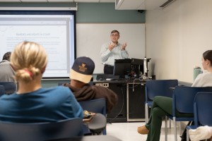Man in white shirt teaches a class. Thomas Jones, professor of Practice of Criminology, at Mount Saint Mary College, teaches a Criminology class