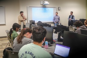 Jonah Goverman, senior offensive security consultant at Unit 42 by Palo Alto Networks, speaks to students alongside fellow Mount alumni Sean Jennings and Jack Santaroni during “A Day in the Life of a Cybersecurity Professional” on October 15.  ALT: Three 