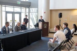 Michael Kearney, Senior Business student and President of the Finance Club, introduces the “Financing Forward: Tips for Your Future Self” panel. Seated from left to right are Kevin Coccomo, Wealth Management Advisor and Managing Director at Northwestern M