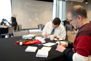 Mount Saint Mary College faculty and staff gather in Guzman Hall to write handwritten Christmas cards to more than 1,400 accepted students during the Office of Admissions’ second annual card-writing party. 