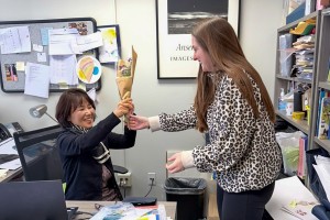 A Mount Saint Mary College student surprises an appreciative professor with a hand-delivered bouquet. 