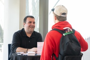 Smiling man speaks to student at Mount Saint Mary College
