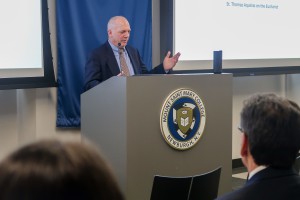 Man at podium, speaking to a group. Robert Miller, associate professor of Religious Studies at Mount Saint Mary College, will present “Climbing Mountains and Dodging Demons: The Dangerous Faith of Frassati and Longo” on Tuesday, April 21. 