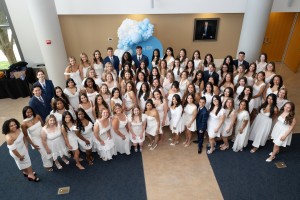 Many people smiling and looking up. Mount Saint Mary College recognized more than 100 graduates of the Nursing program at a pinning ceremony on Friday, May 15.