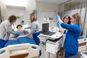 Lynette DeBellis (second from right), associate professor and Chair of the School of Nursing at Mount Saint Mary College, teaches students in the simulation lab. 
