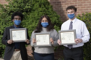 From left to right: Dajon Atkins, Sharee Powell, and Edward Arnold standing outside holding their award.