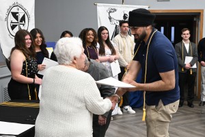 Man shakes hands with woman at ceremony. Biology student Parmveer Singh of Middletown, N.Y. was recognized as an Aquinas Scholars at Mount Saint Mary College’s Induction Ceremony of Aquinas Scholars, Ralph Scholars and Boyle Scholars on Wednesday, April 8