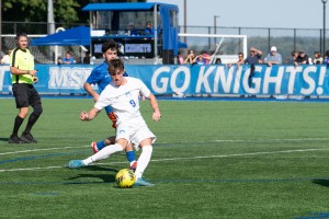 ALT: Man kicks ball during soccer game at Mount Saint Mary College.