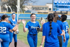 ALT: Women congratulate each other after a softball game at Mount Saint Mary College.
