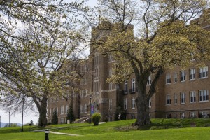 Mount Saint Mary College's Dominican Center behind two blooming trees.