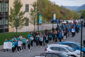 Dozens of people walking and holding signs. Mount Saint Mary College community took part in the annual Take Back the Night event on Monday, April 20 to honor survivors of sexual violence. 