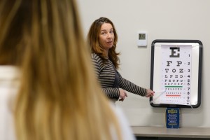 Anne-Marie Uebbing, associate professor of Nursing at Mount Saint Mary College and a certified Family Nurse Practitioner, provides vision testing during a joint project with the college’s School of Nursing and the Desmond Center for Community Engagement a
