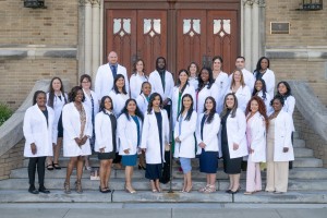 Men and women in white coats at Mount Saint Mary College. 