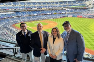 Men and women at Yankees Stadium. Mount Saint Mary College faculty and staff, left to right: Kyle Teixeira, director of Sports Information; Michael L. Fox, J.D., Acting Dean of the School of Business and associate professor of Business Law; Brooke Yerger,