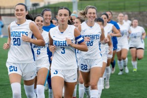 Women's Soccer team running in two lines. 