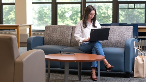 Adult learner sitting on a couch.