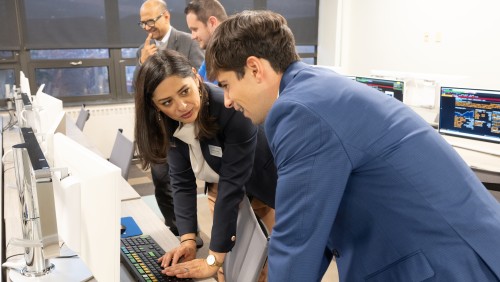 Student working with a faculty member in the college's investment lab.