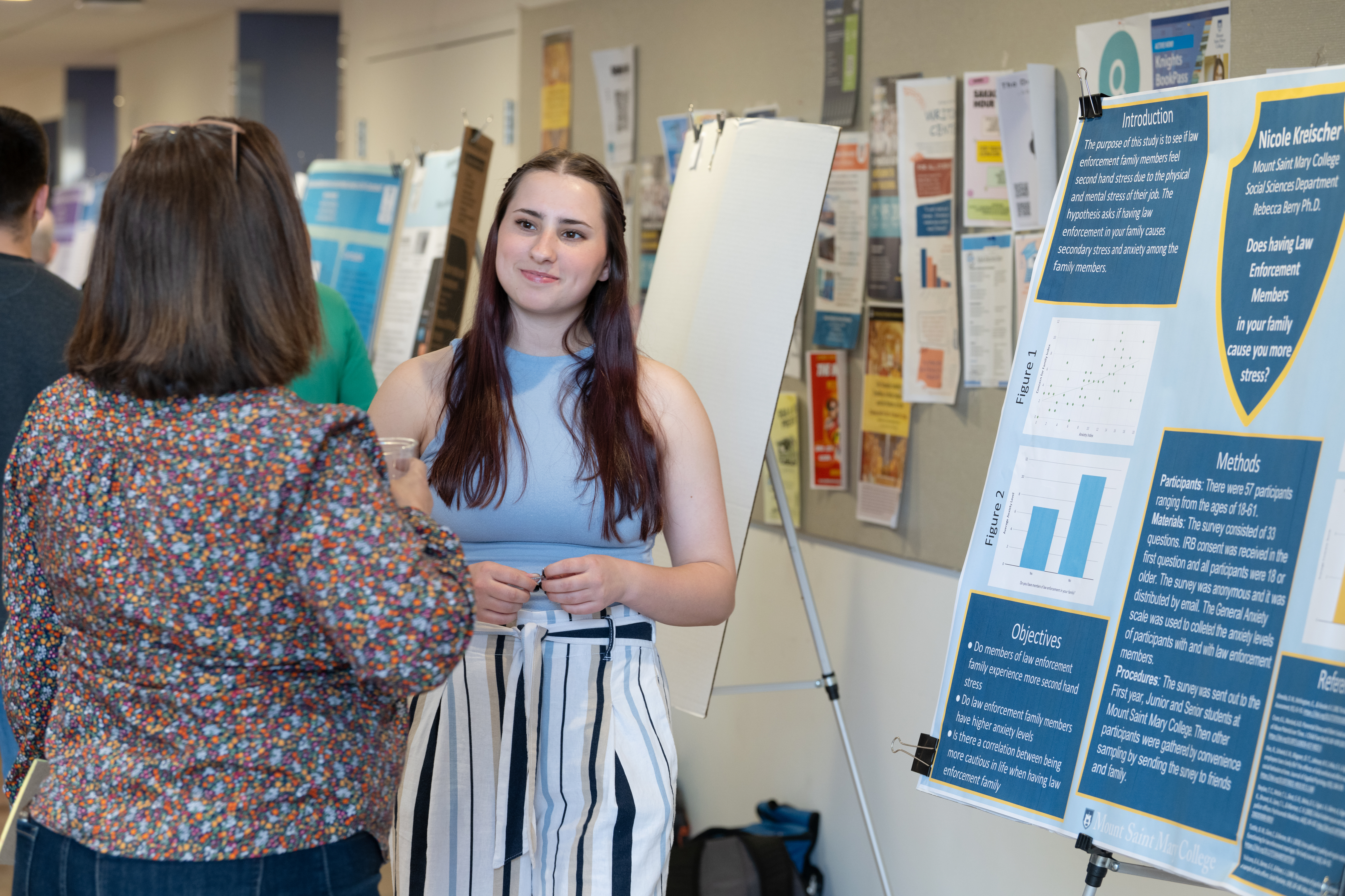 Student presenting research in poster form