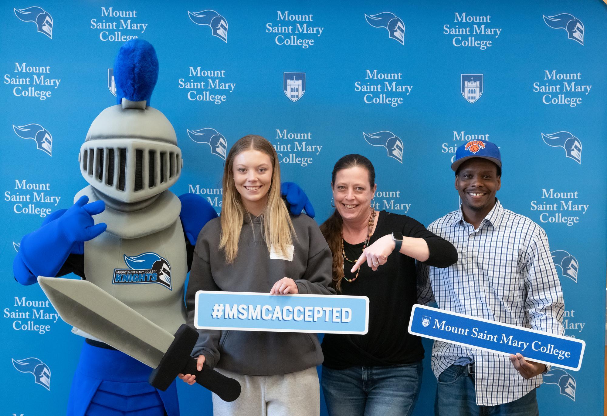 Mack the Knight with a family at Accepted Student Day.