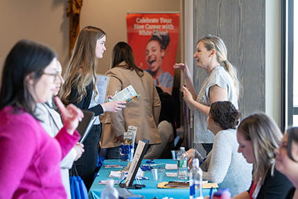 A student talking to a representative at a recent Job Fair held on campus.