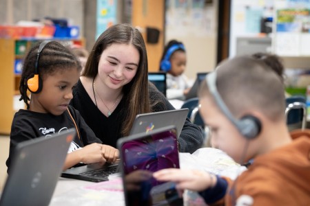 Student teaching young children.