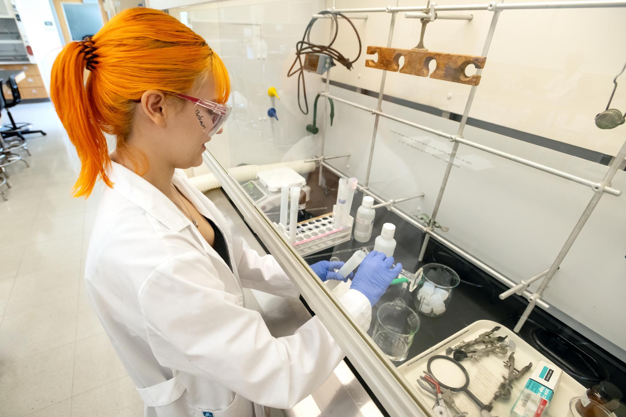Student examining with a microscope